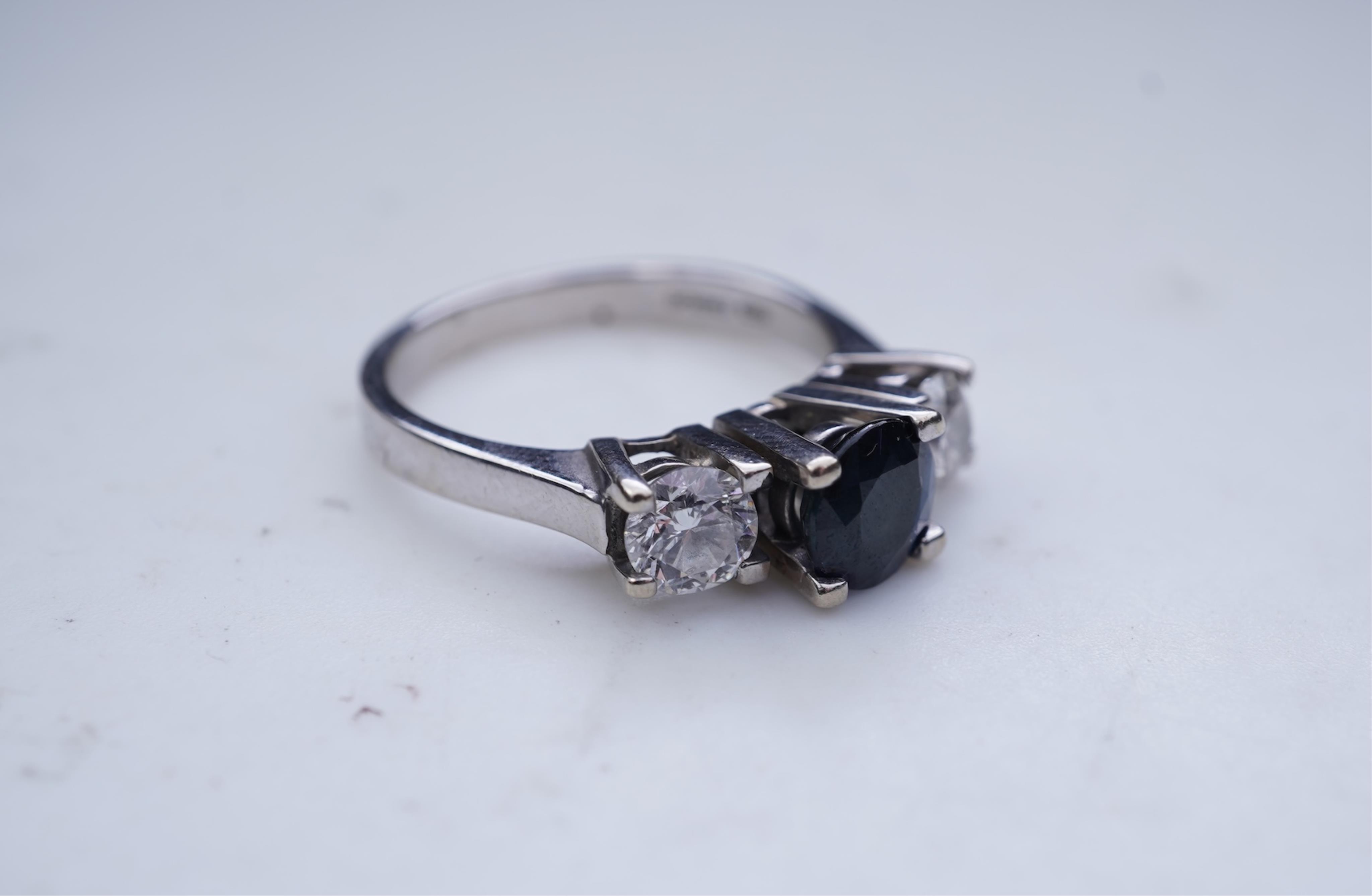 A sapphire and diamond three-stone ring